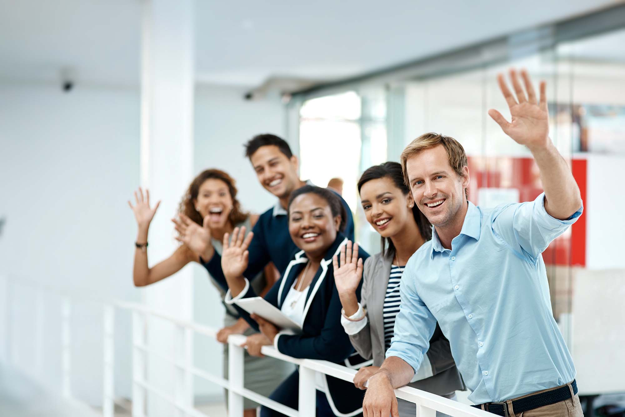 Happy, business people and hand waving to new employee for hello, support and recruitment on office balcony. Smile, corporate group and team with welcome greeting for onboarding and collaboration