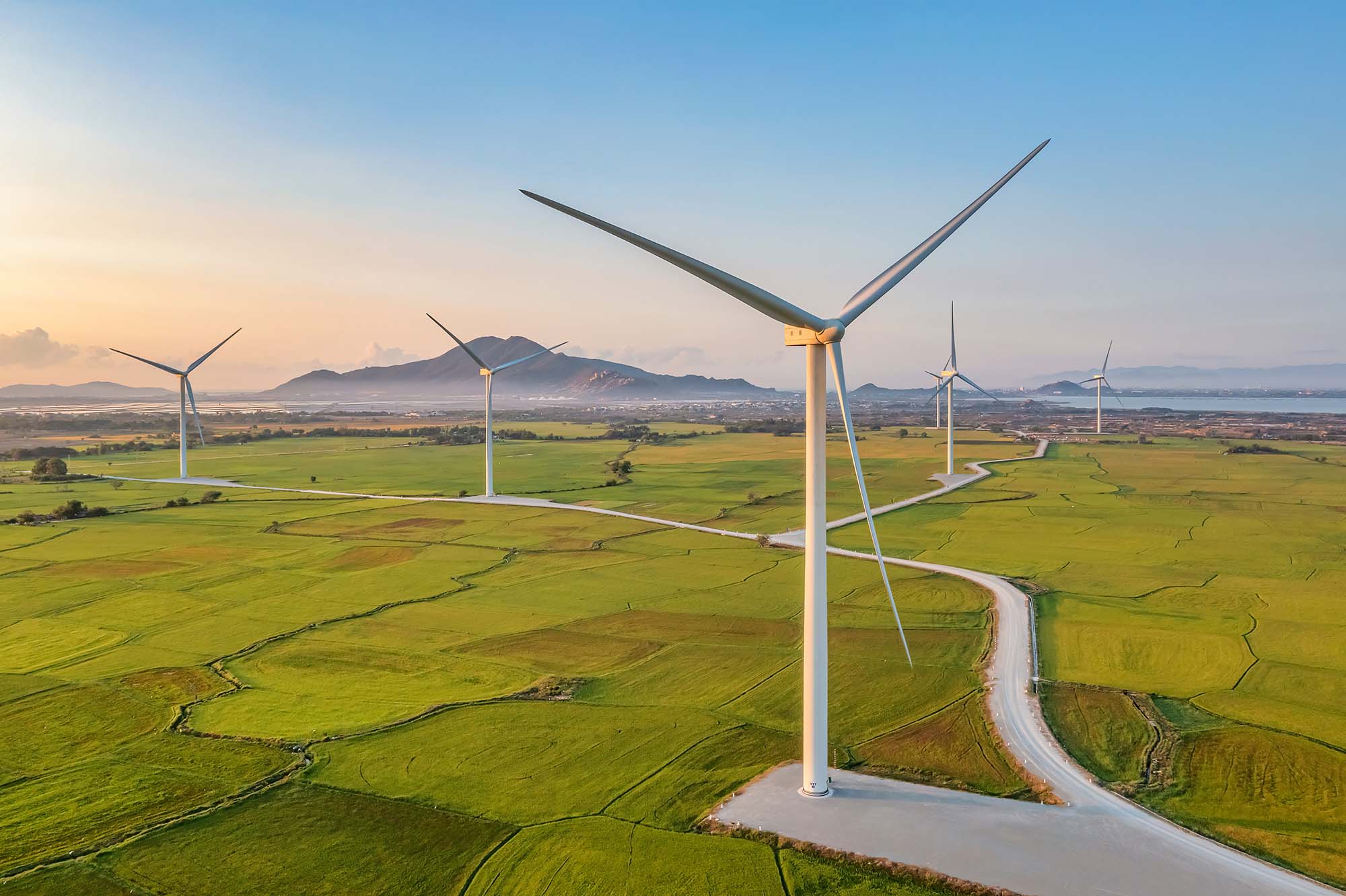 Panoramic view of wind farm or wind park, with high wind turbine